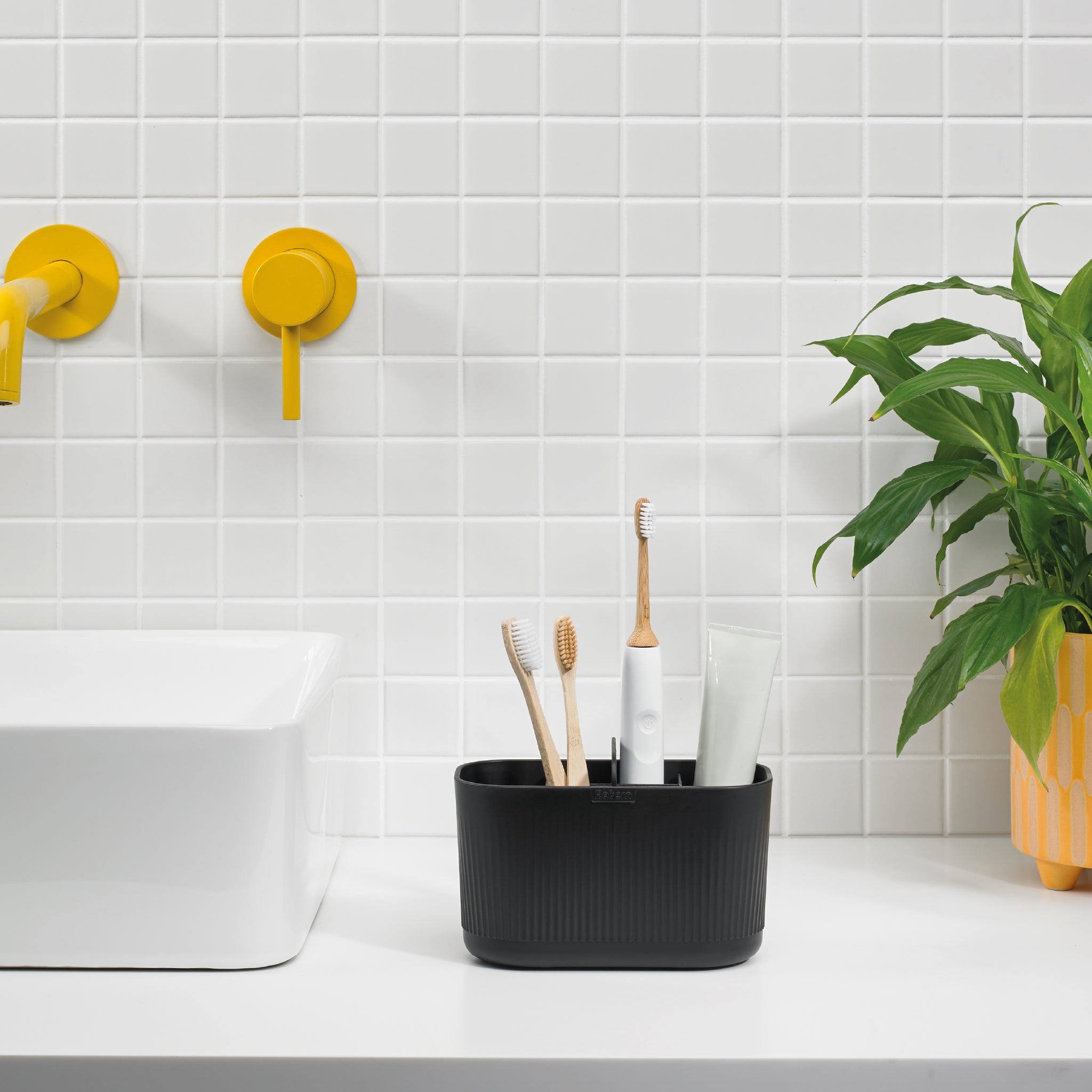 Black ReBorn bathroom caddy keeps essentials organized, reducing clutter on countertops.