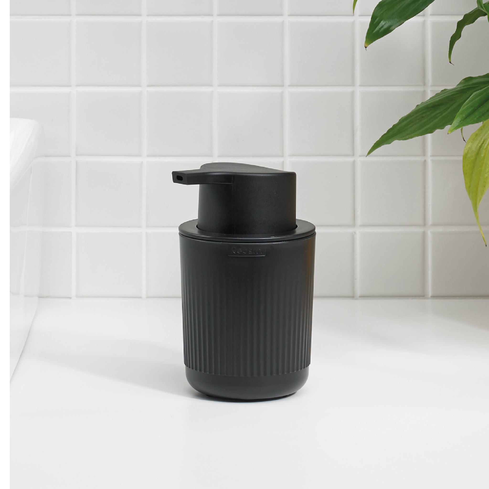 ReBorn black ribbed soap dispenser with a sleek design, perfect for modern bathrooms or kitchens.