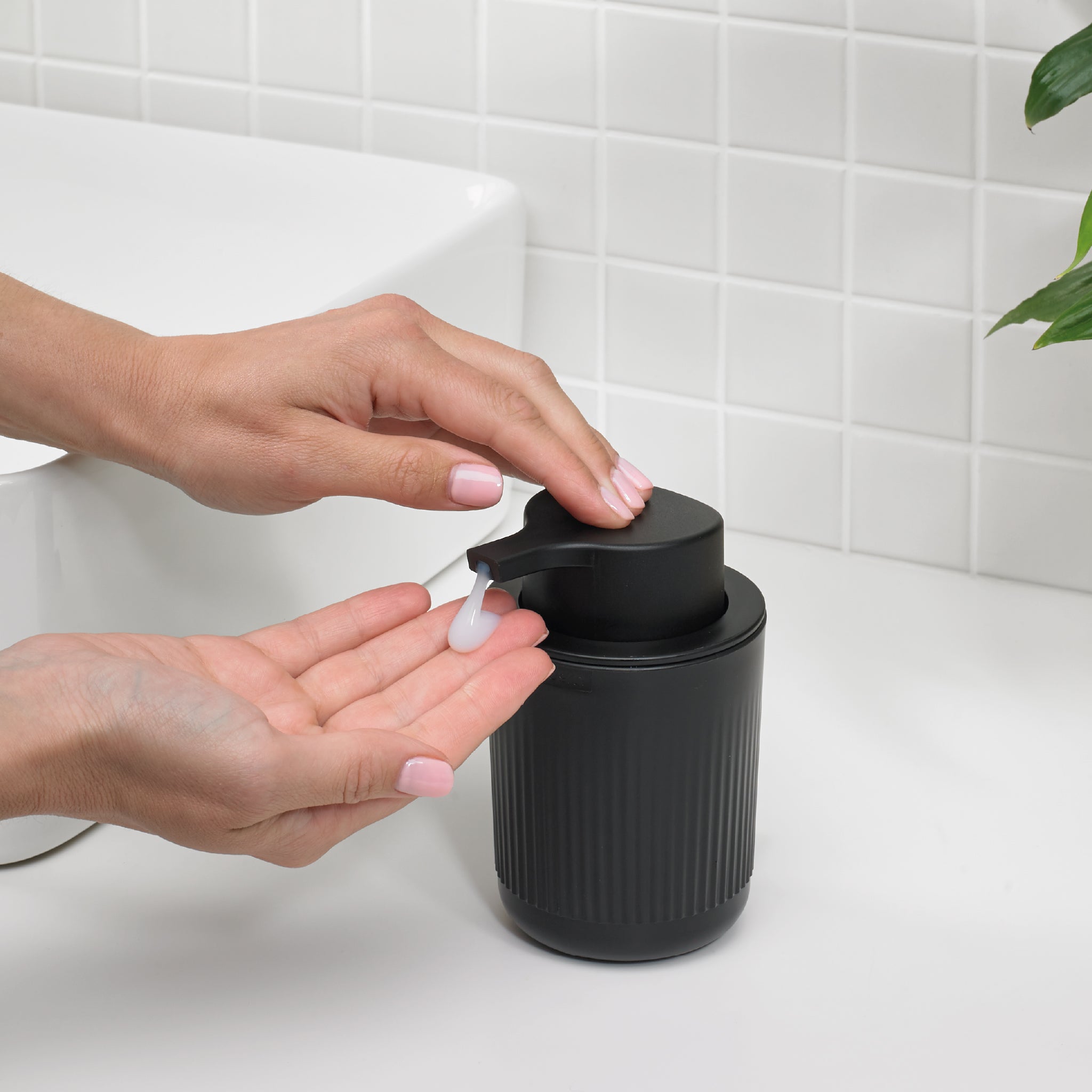 Sleek black soap dispenser with modern grooves, a smooth pump, and a stylish bathroom upgrade.