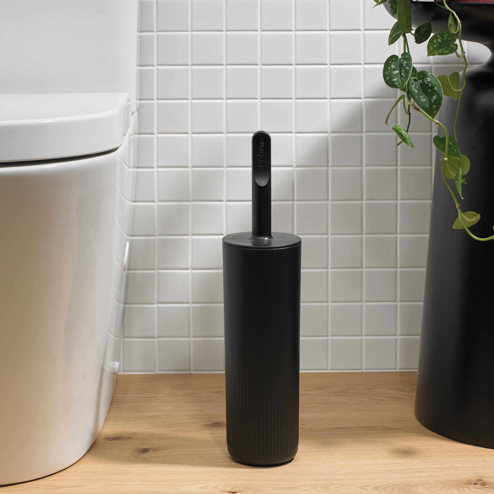 Sleek black toilet brush with hygienic holder, modern design, and durable bristles for efficient cleaning.
