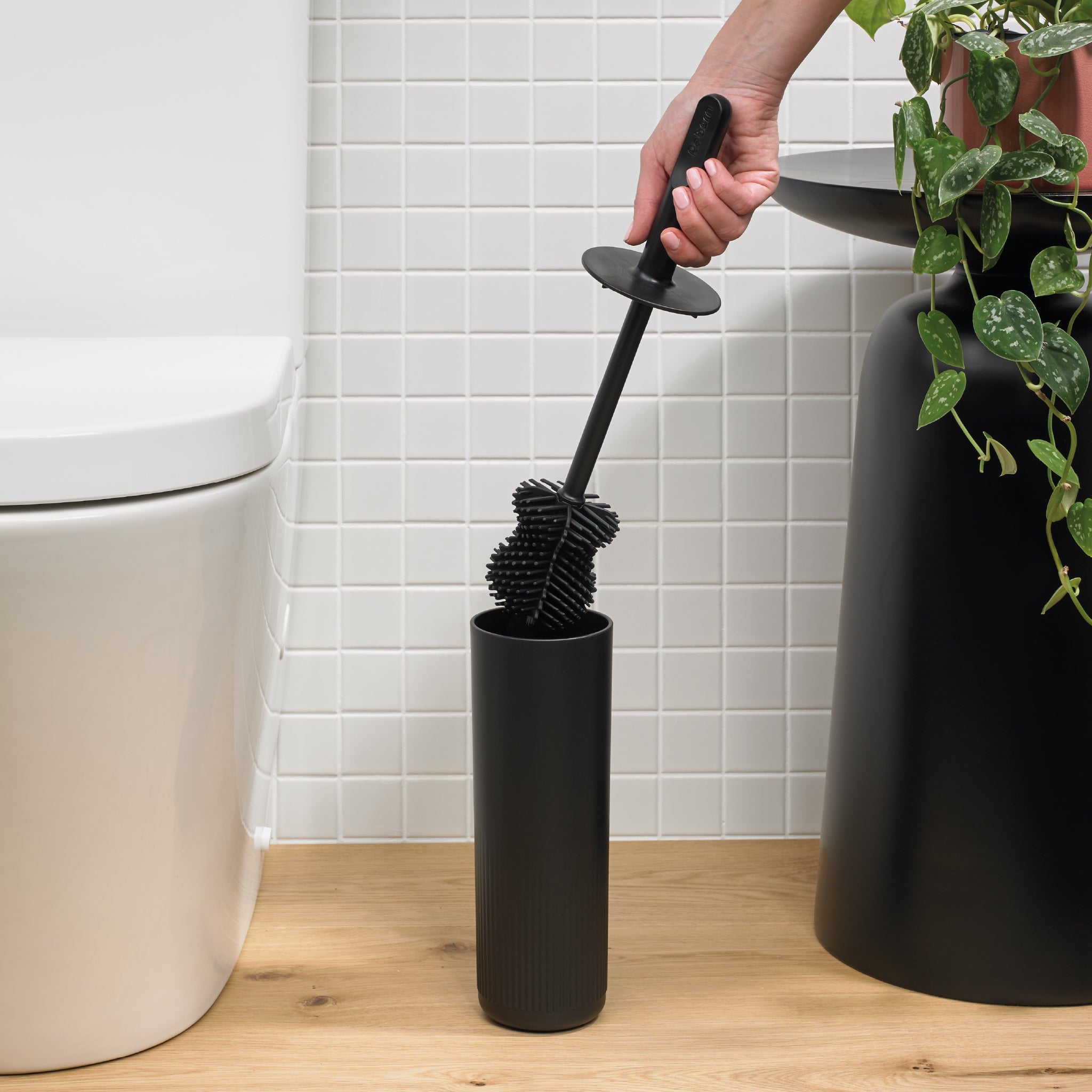 ReBorn black silicone toilet brush with holder, non-scratch design for deep, hygienic cleaning.