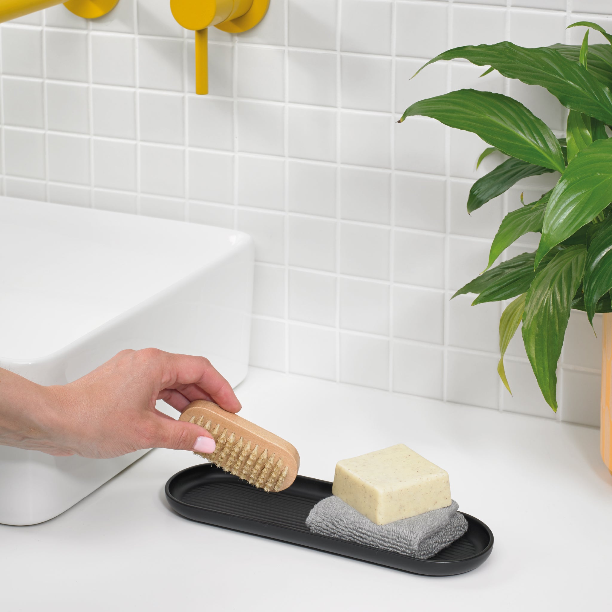 Black ReBorn bathroom tray with textured base, perfect for organizing soaps, towels, and essentials.