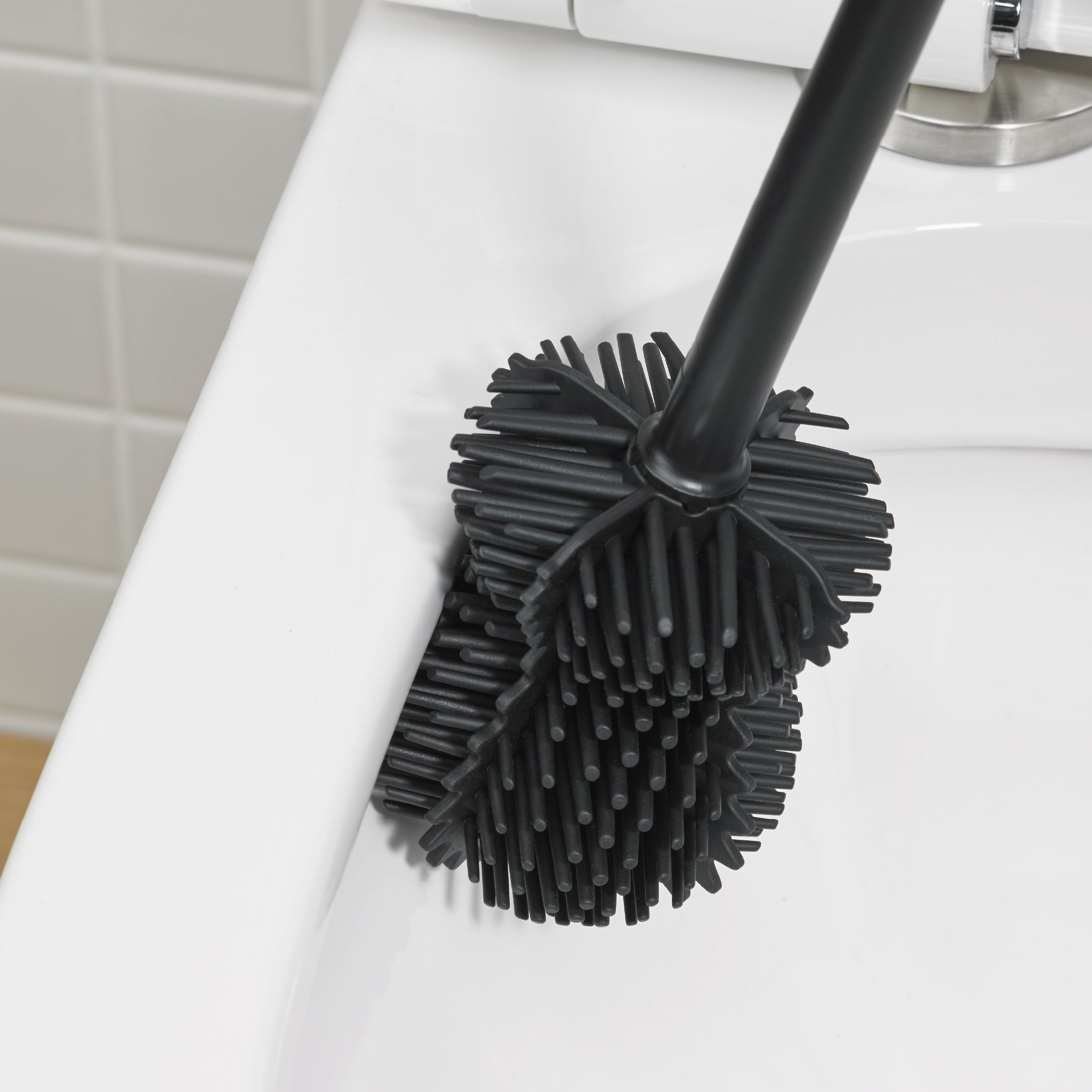 Flexible black toilet brush head with dense bristles for thorough, scratch-free toilet cleaning.