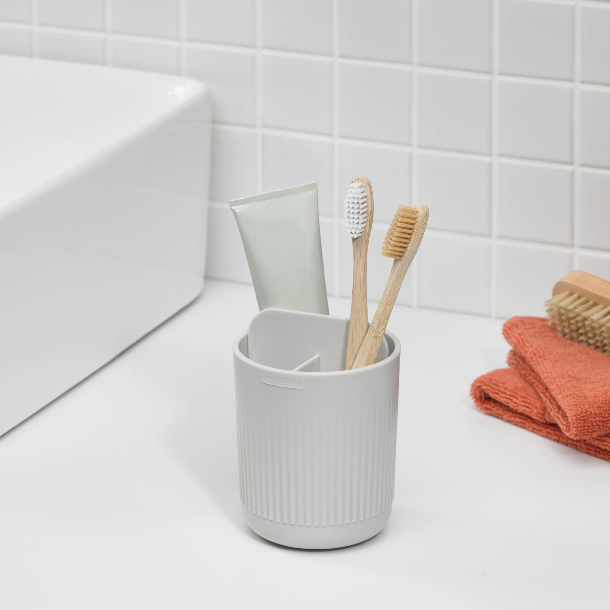 ReBorn toothbrush holder, minimalist ribbed design, keeps brushes organized and counters clutter-free.
