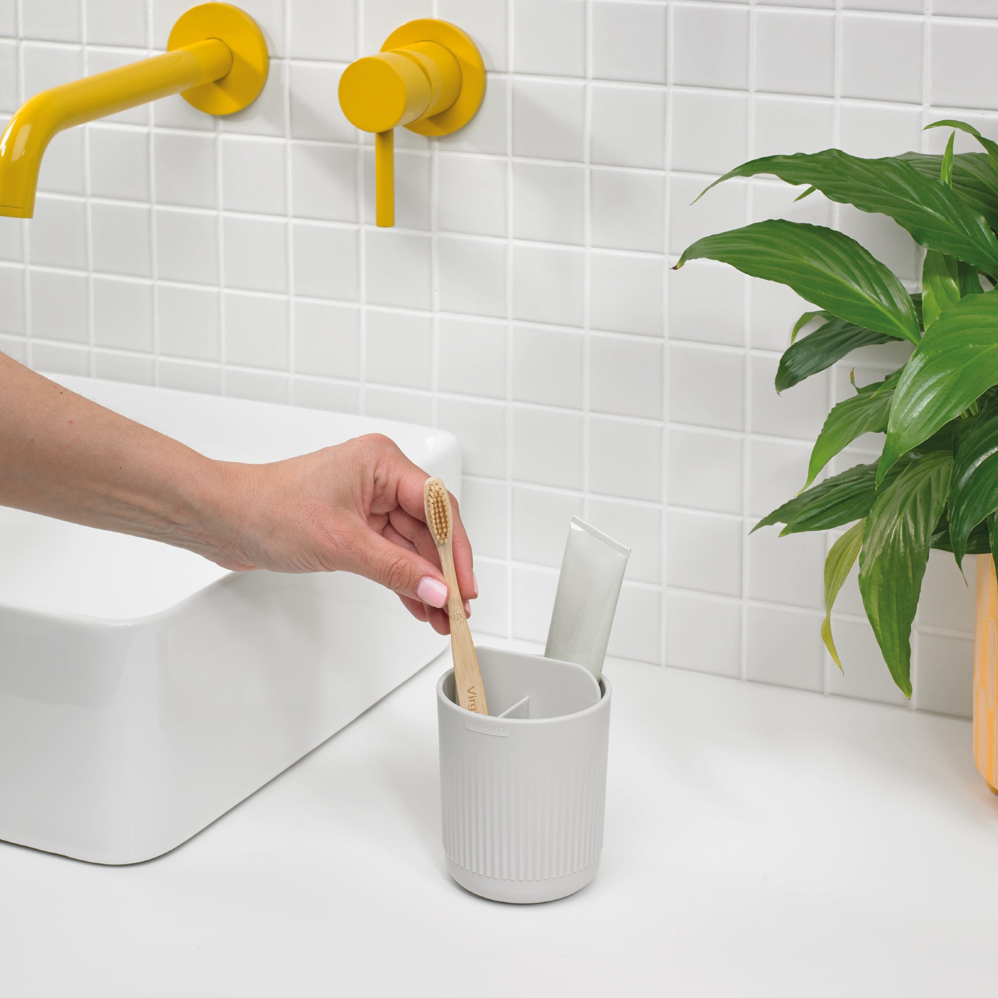 Modern ribbed toothbrush holder in graphite black, keeps essentials organized with a sleek, minimalist design.