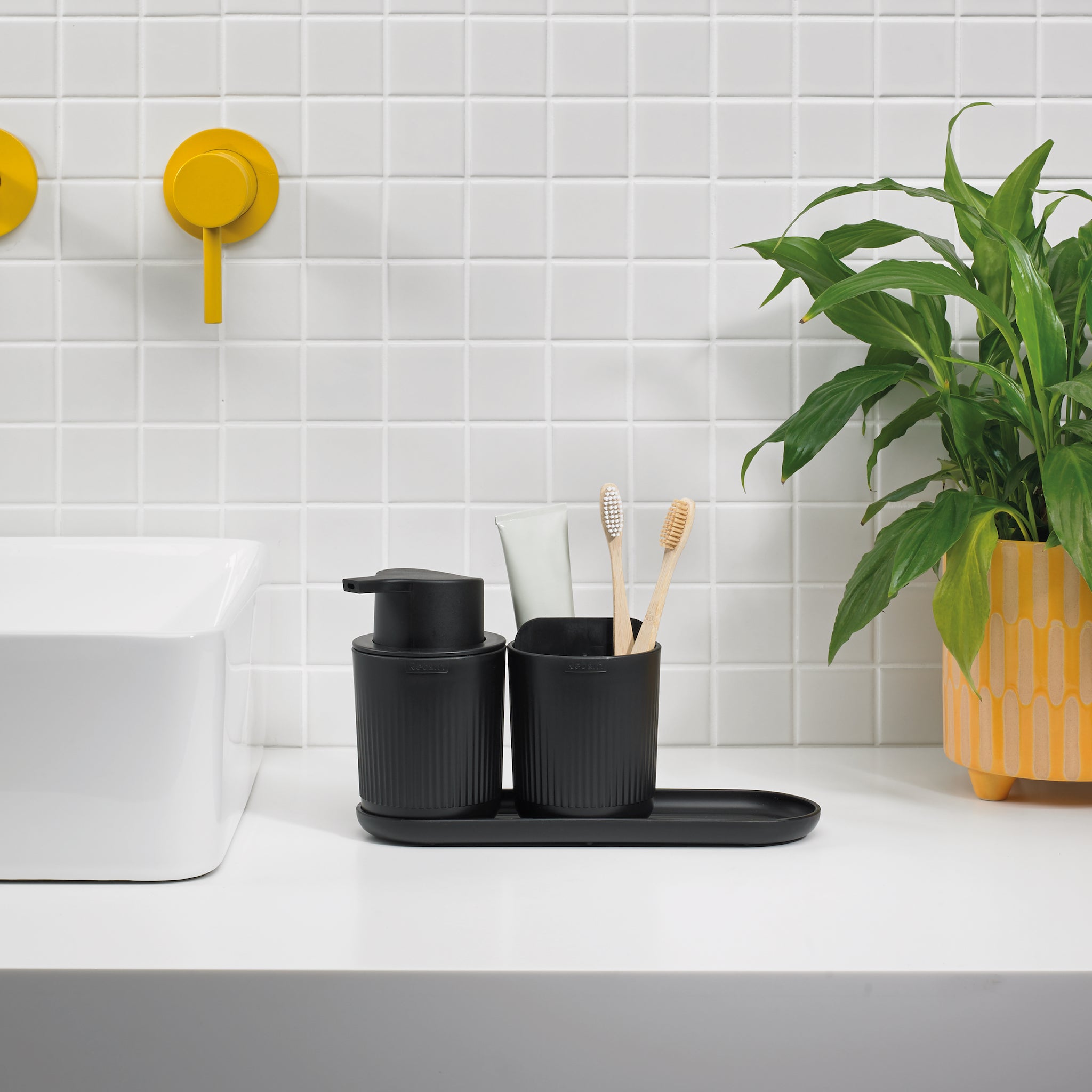 ReBorn black ribbed bathroom set with soap dispenser and toothbrush holder, stylish and organized.