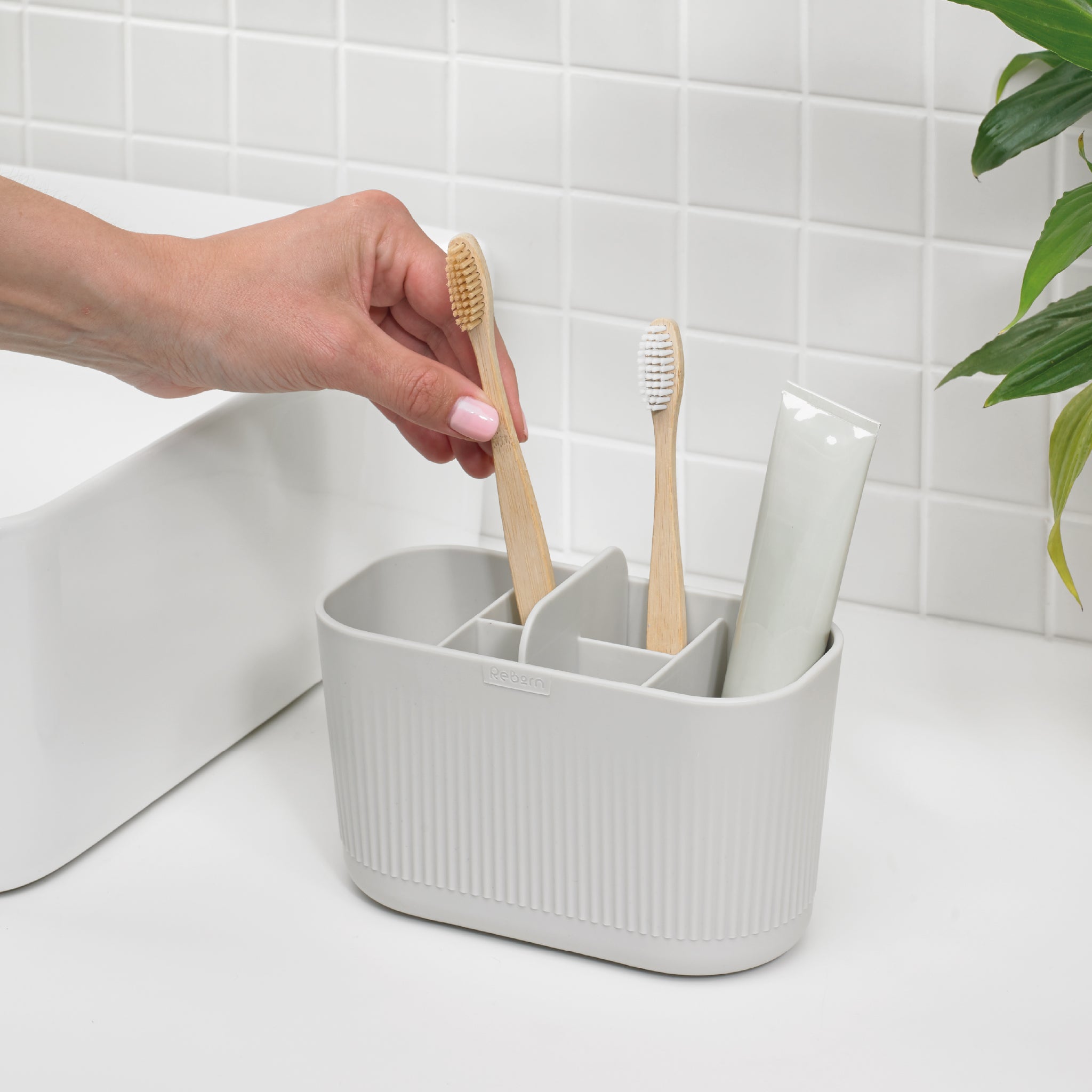 Large grey bathroom caddy with multiple compartments, perfect for organizing toothbrushes and toiletries.