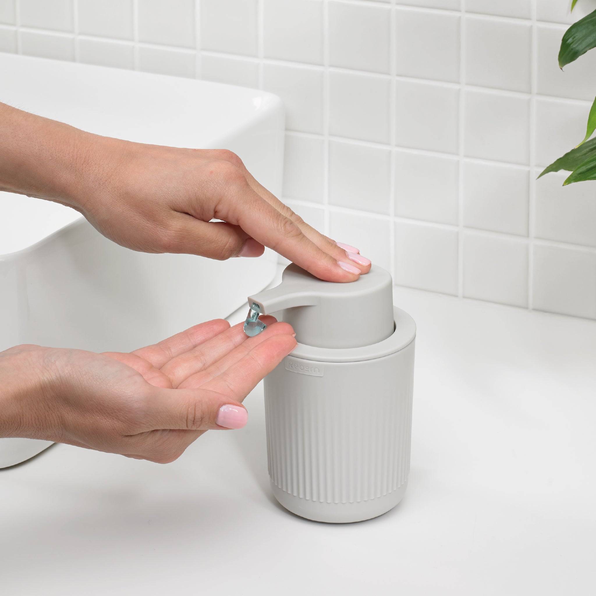 Matte gray soap dispenser with a non-slip ridged texture for easy grip and mess-free use.