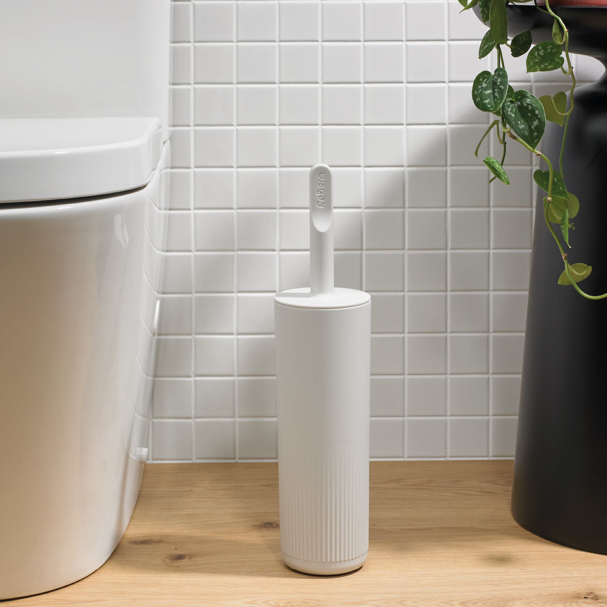Modern toilet brush set with a stylish textured holder, designed for discreet, hygienic storage.