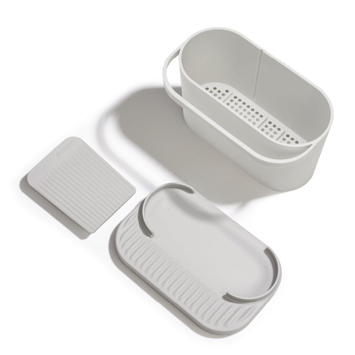 Recycled kitchen sink tidy with drainage holes, keeps sponges and brushes dry and organized.