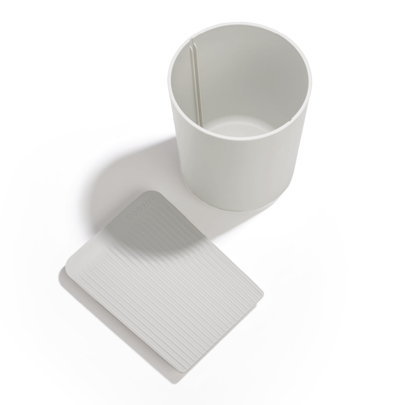 Eco-friendly recycled utensil holder, minimalist design, durable build, perfect for organizing kitchen tools.