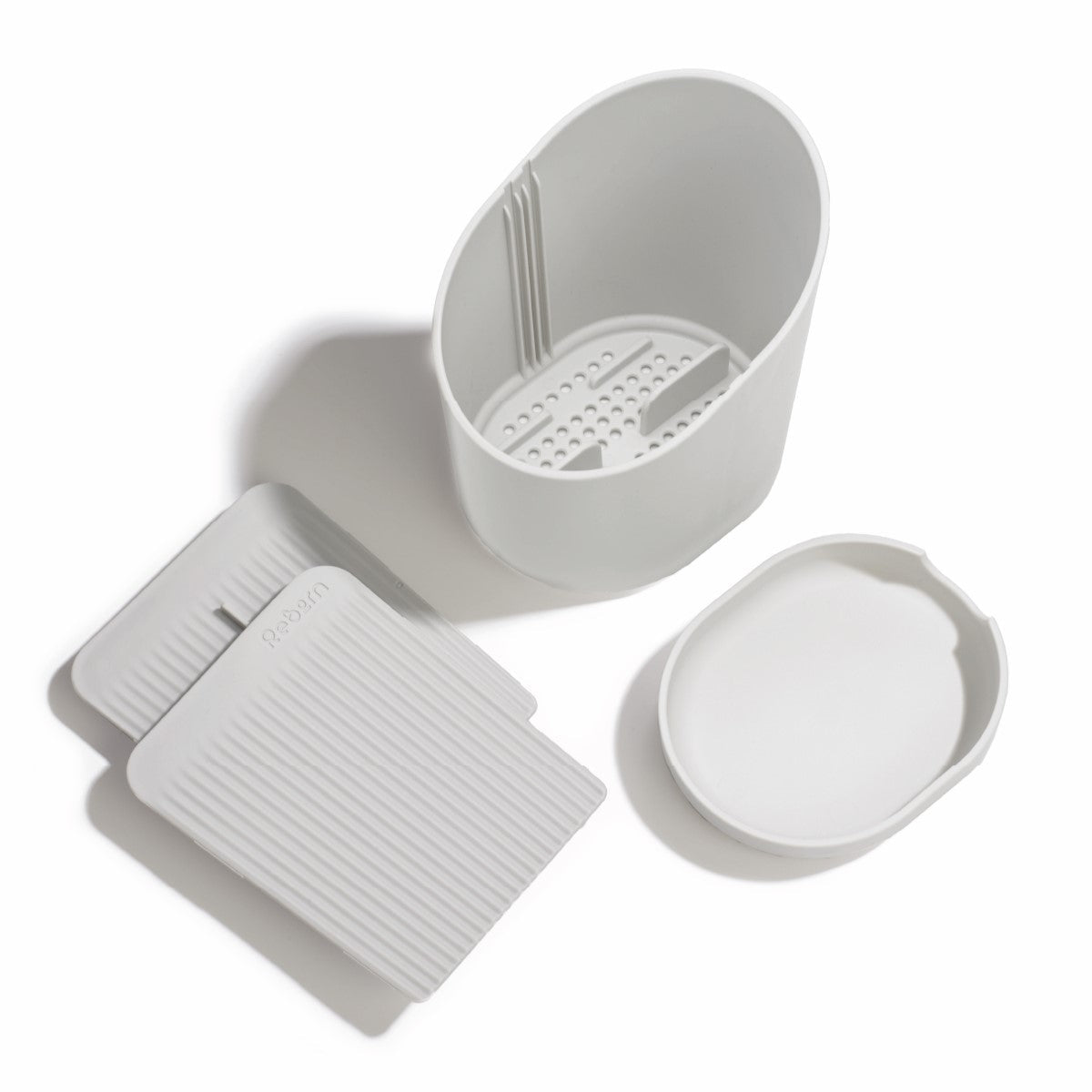 Eco-friendly recycled cutlery drainer with dividers, drainage holes, and a detachable base for a dry, organized kitchen.