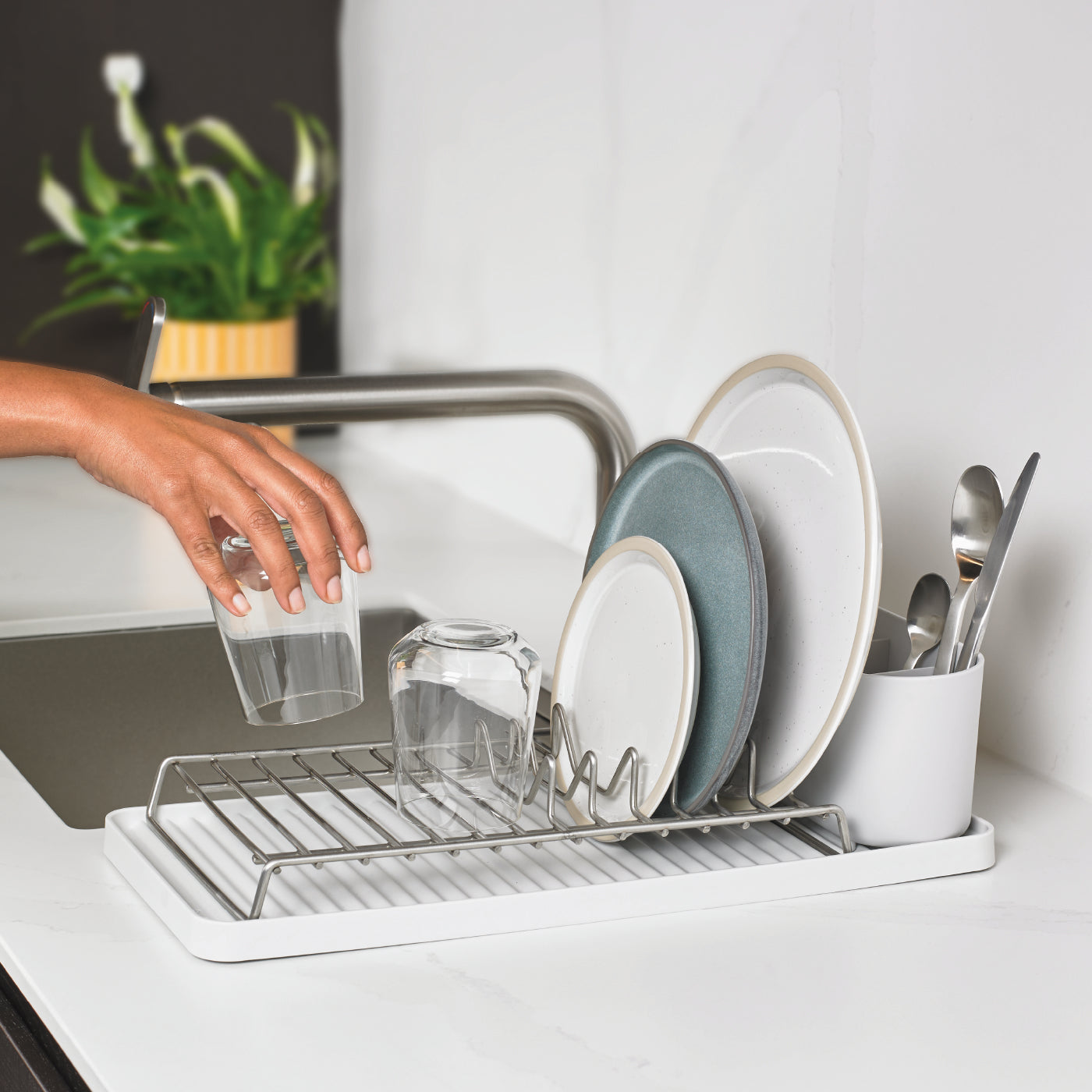 Compact recycled dish drying rack with sleek design, ideal for small kitchens and efficient drainage.