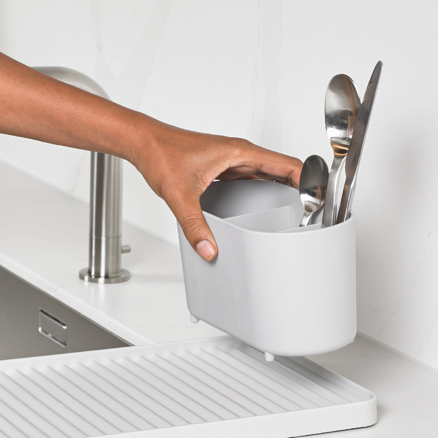 Compact recycled draining rack, efficiently organizes utensils while draining excess water for quick drying.