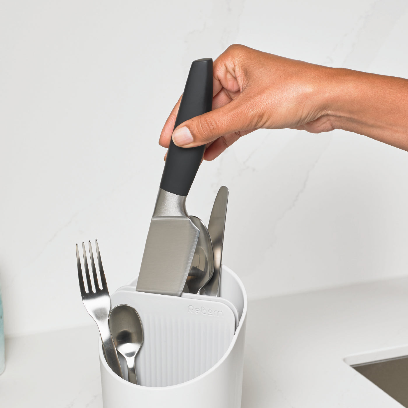 Eco-friendly recycled cutlery drainer with textured design, keeps utensils organized and within reach.