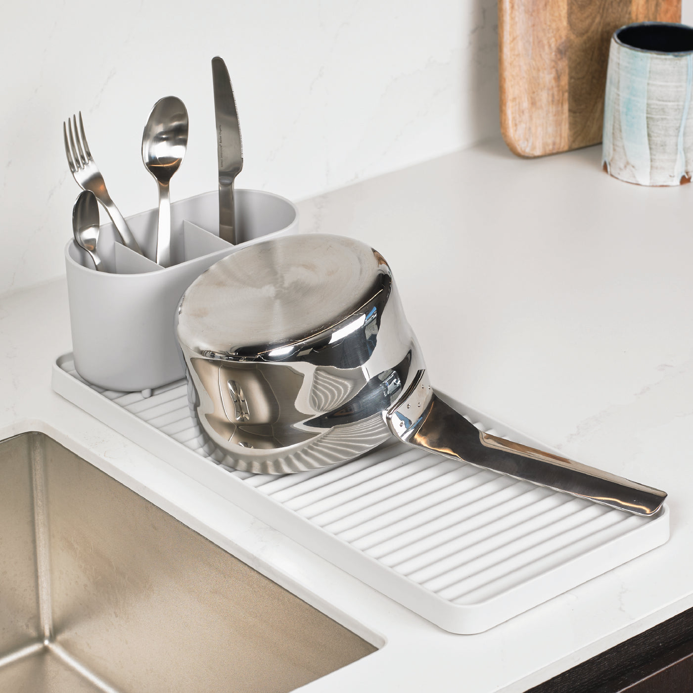 Compact recycled draining rack with ribbed surface, perfect for small kitchens and eco-friendly drying.