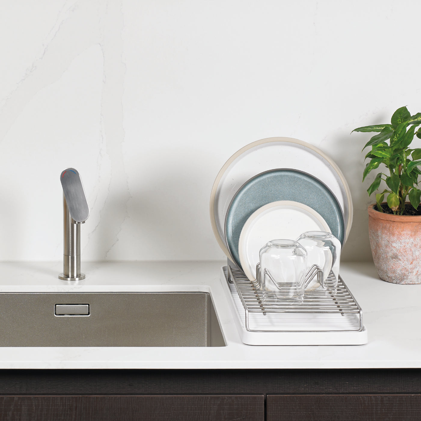 Compact recycled dish-drying rack with a sleek design, perfect for small kitchens and eco-friendly living.