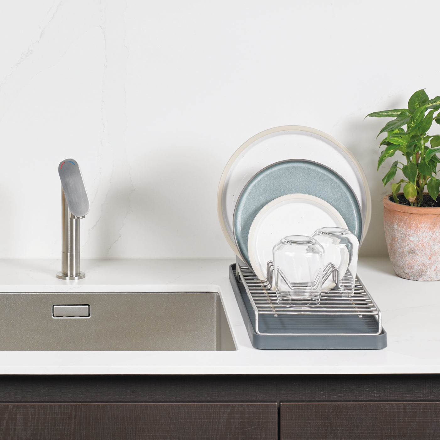 Compact recycled dish rack, efficiently drains dishes while saving space—eco-friendly and durable design.