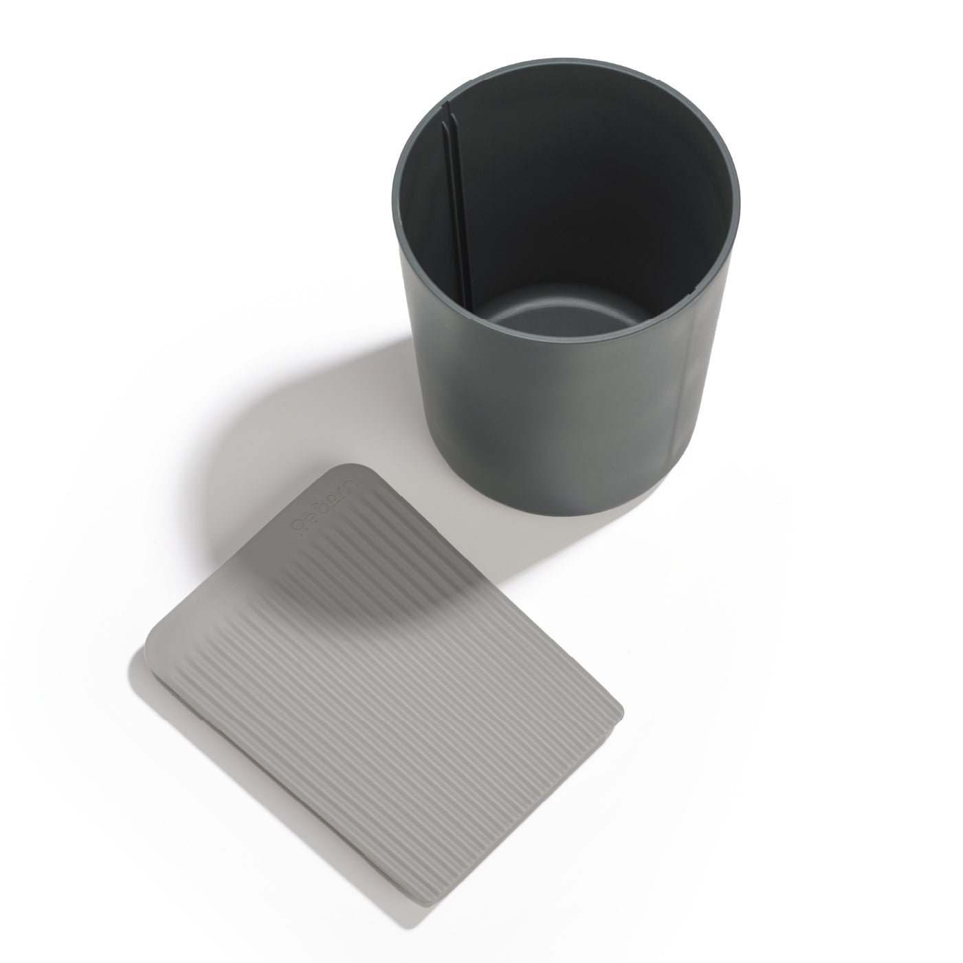 ReBorn recycled utensil holder with modern minimalist design, sustainable materials, and a built-in drip tray.