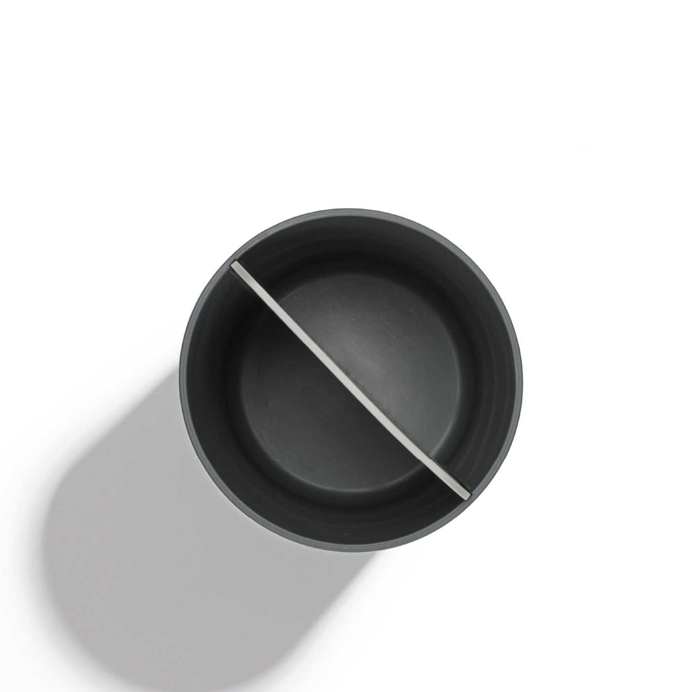 Recycled utensil holder with a sleek, matte finish and dual-section design for organized storage.