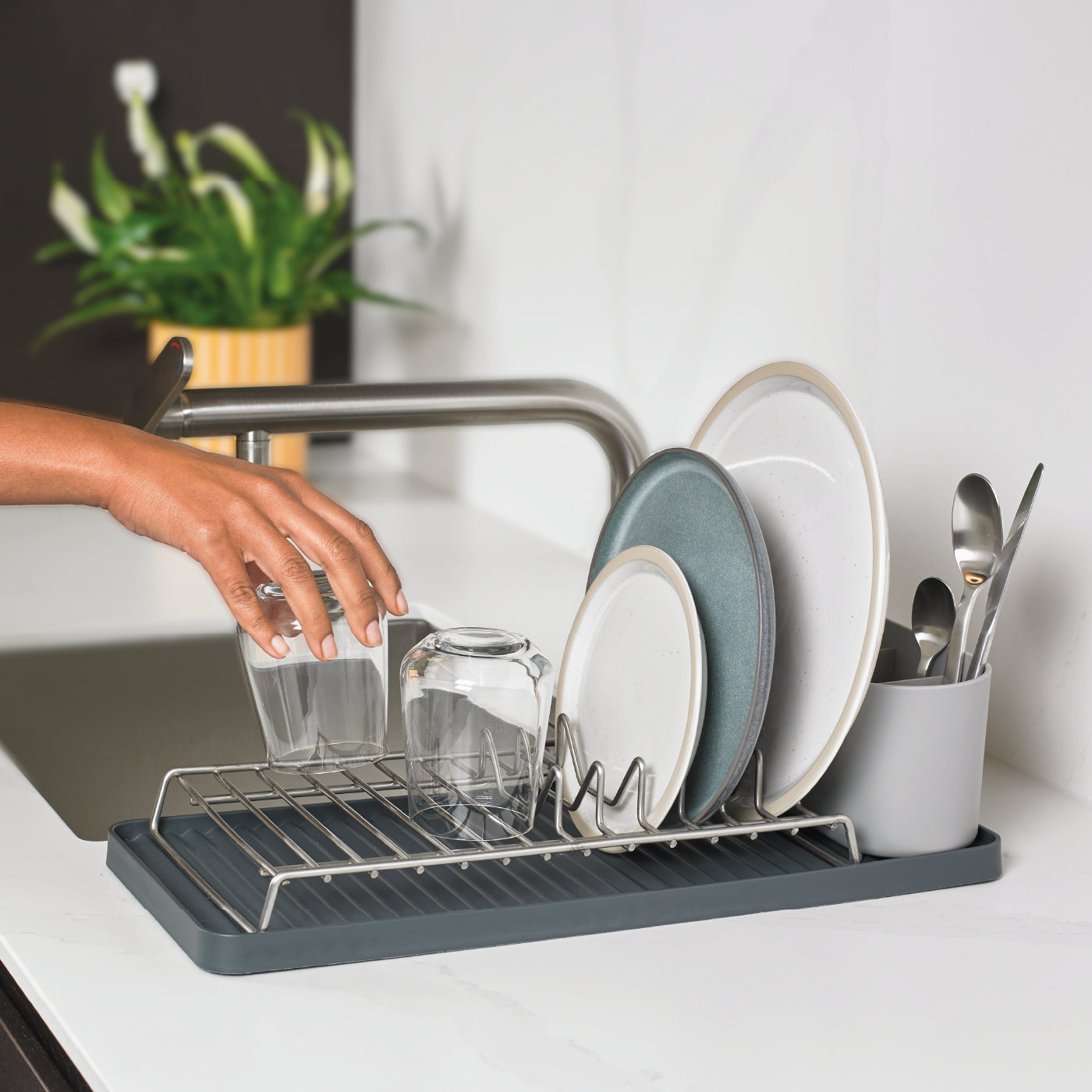 Compact recycled dish drying rack with drainage tray, perfect for small kitchens and eco-friendly homes.