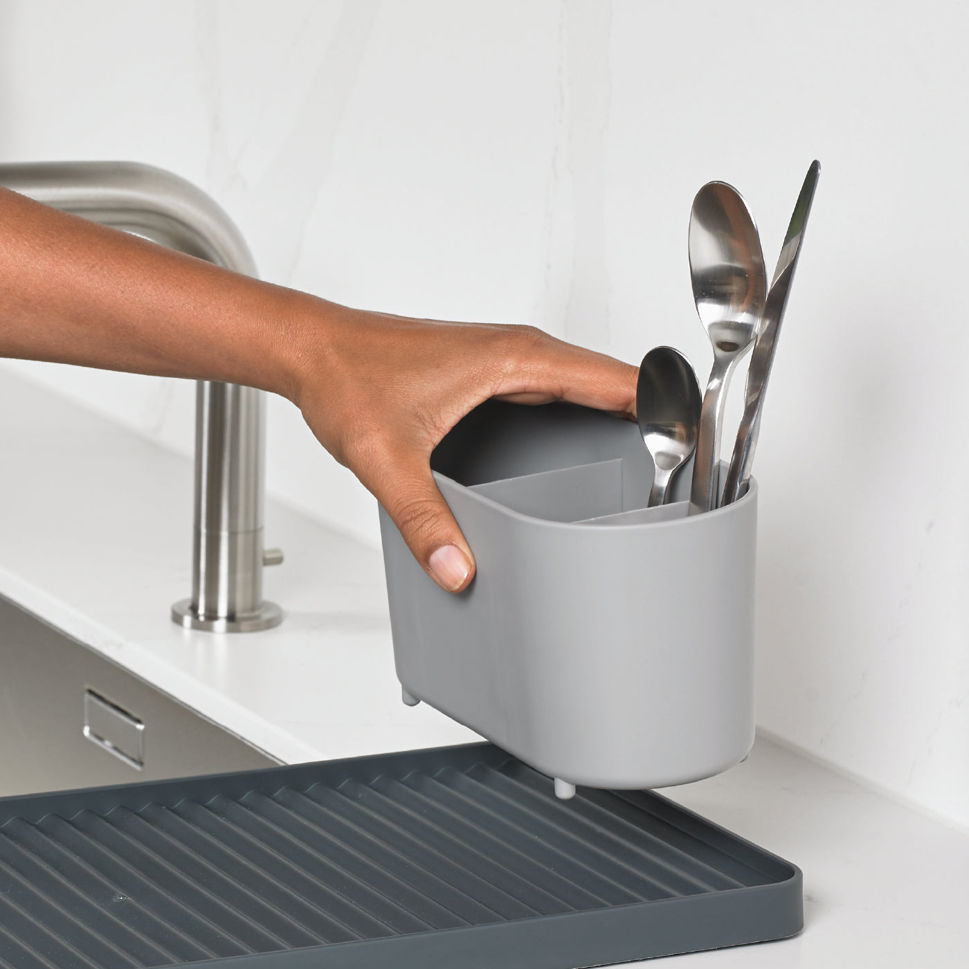 Compact recycled draining rack by ReBorn, with utensil holder and efficient water drainage.