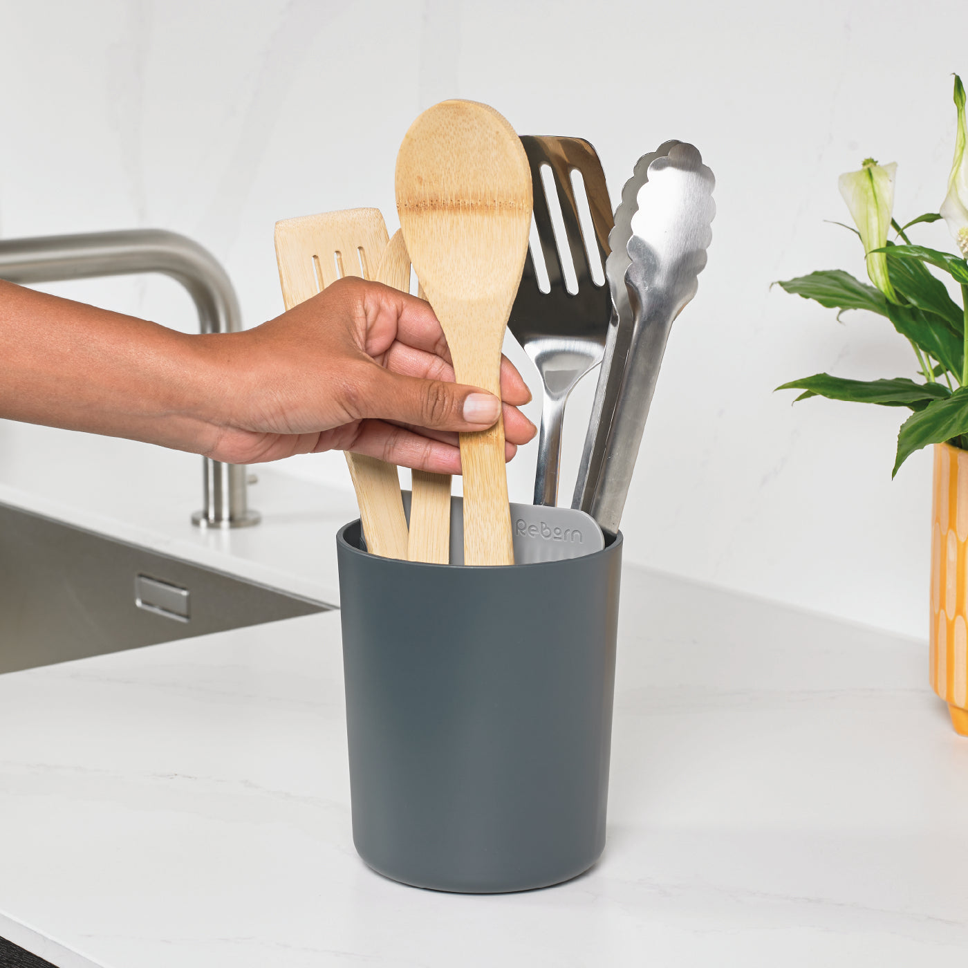 Recycled utensil holder with a sleek grey finish, perfect for organizing kitchen tools sustainably.