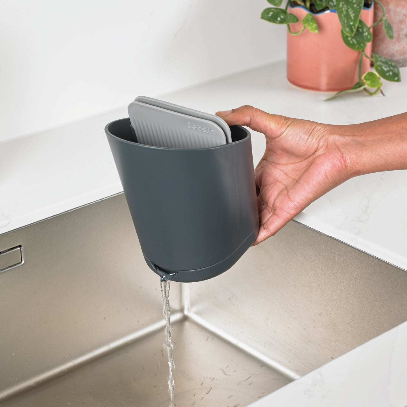 Recycled cutlery drainer with built-in spout for easy water drainage, keeping utensils dry.