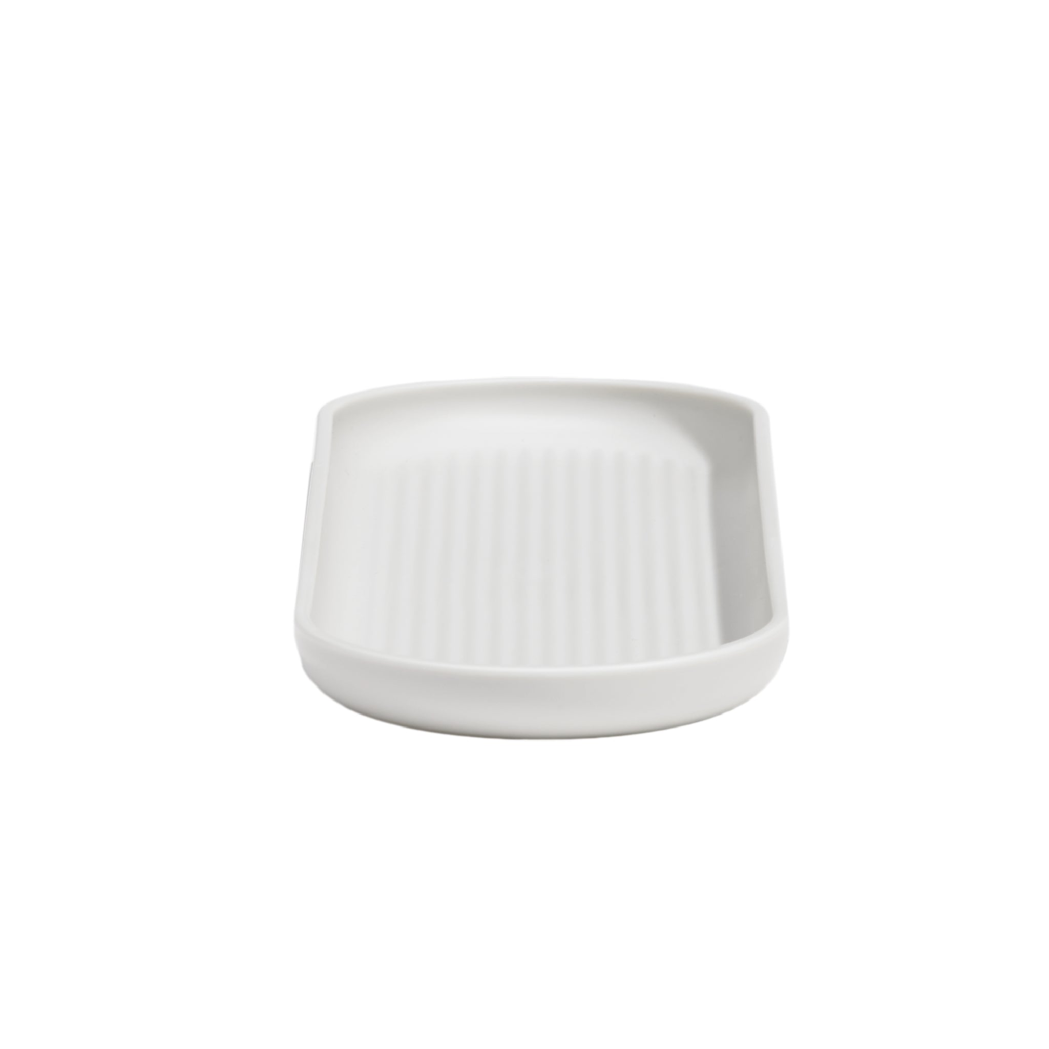 White bathroom tray with raised edges and drainage grooves, perfect for organizing toiletries neatly.