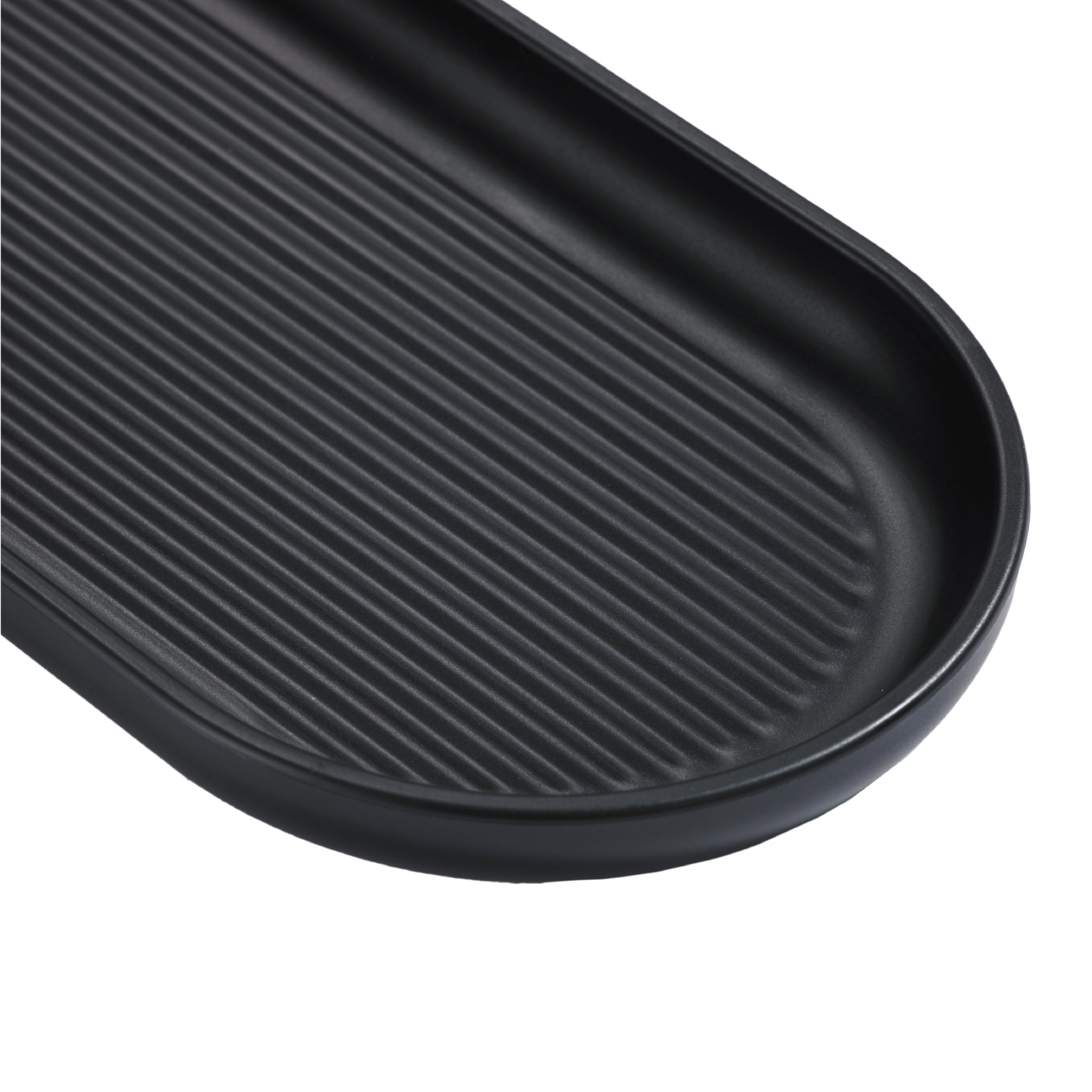 Sleek black bathroom tray with ridged design, perfect for organizing toiletries in a modern space.