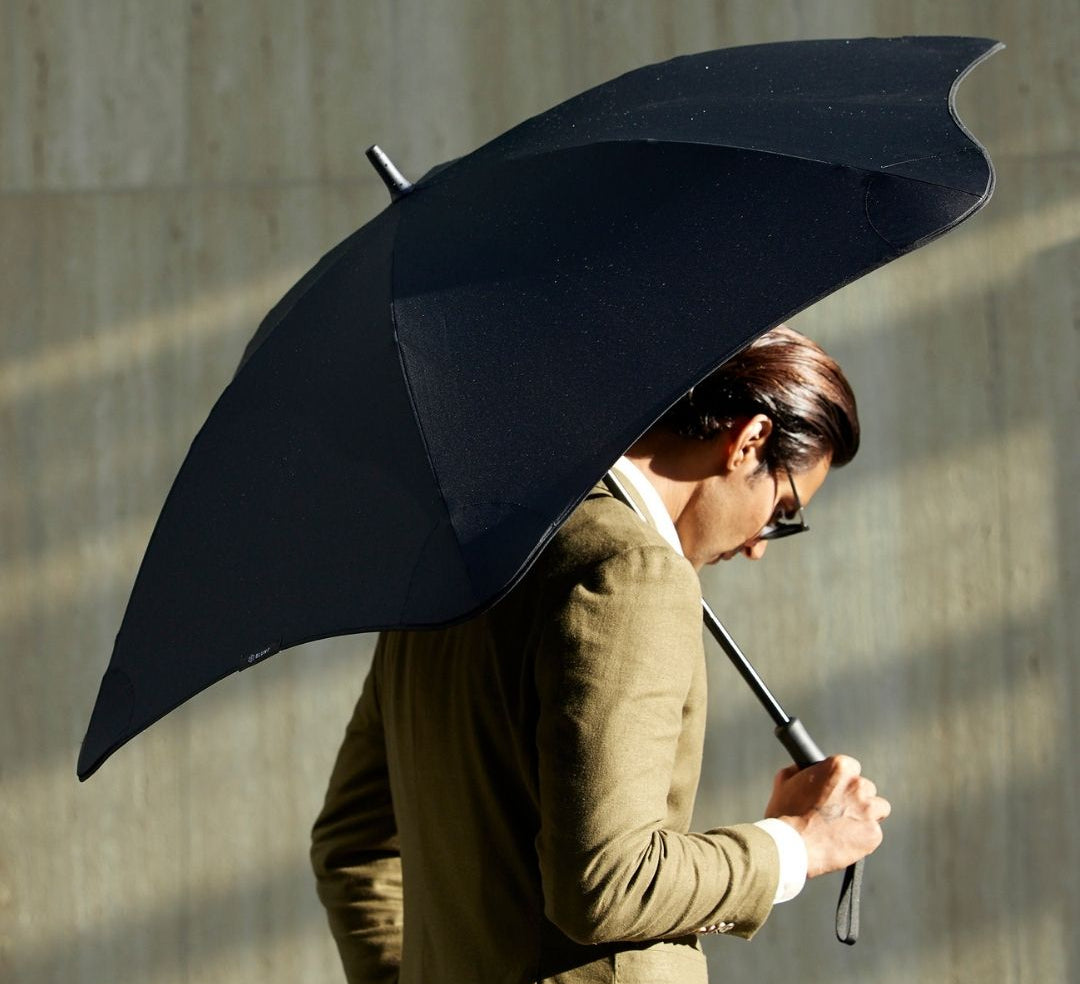 Man holding large black quality umbrella