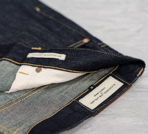 Closeup detail of raw selvedge jeans