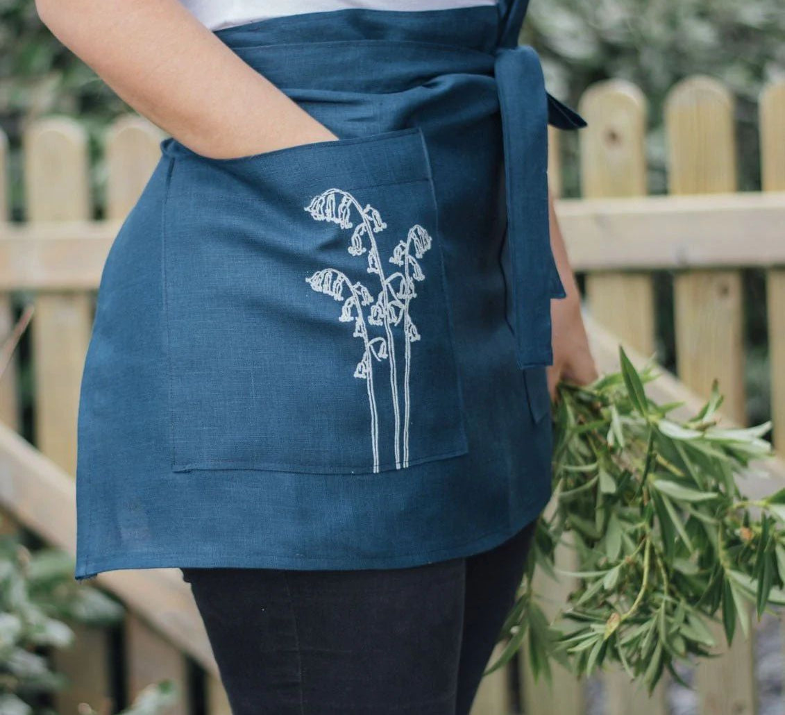 Blue linen half apron with flower detail