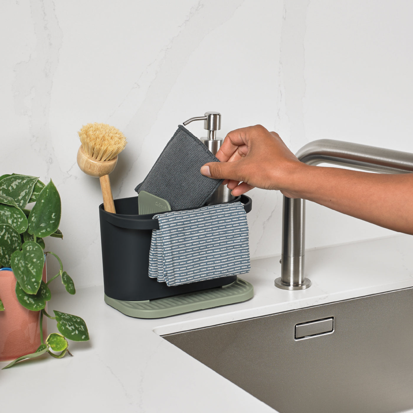 ReBorn Recycled Kitchen Sink Tidy keeps sponges, brushes, and cloths organized with a drainable base.