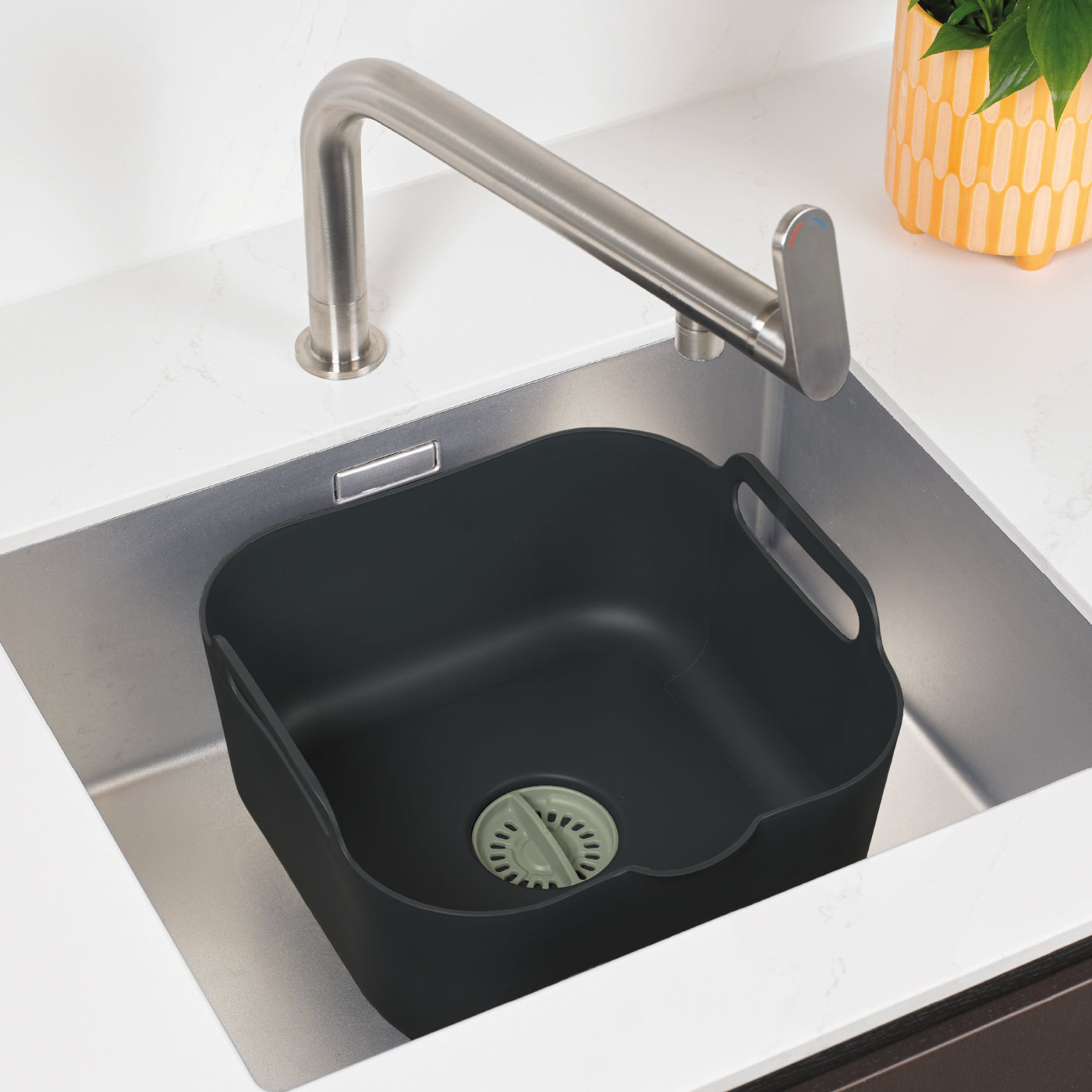 Recycled washing up bowl with built-in strainer, easy-lift handles, and eco-friendly design.