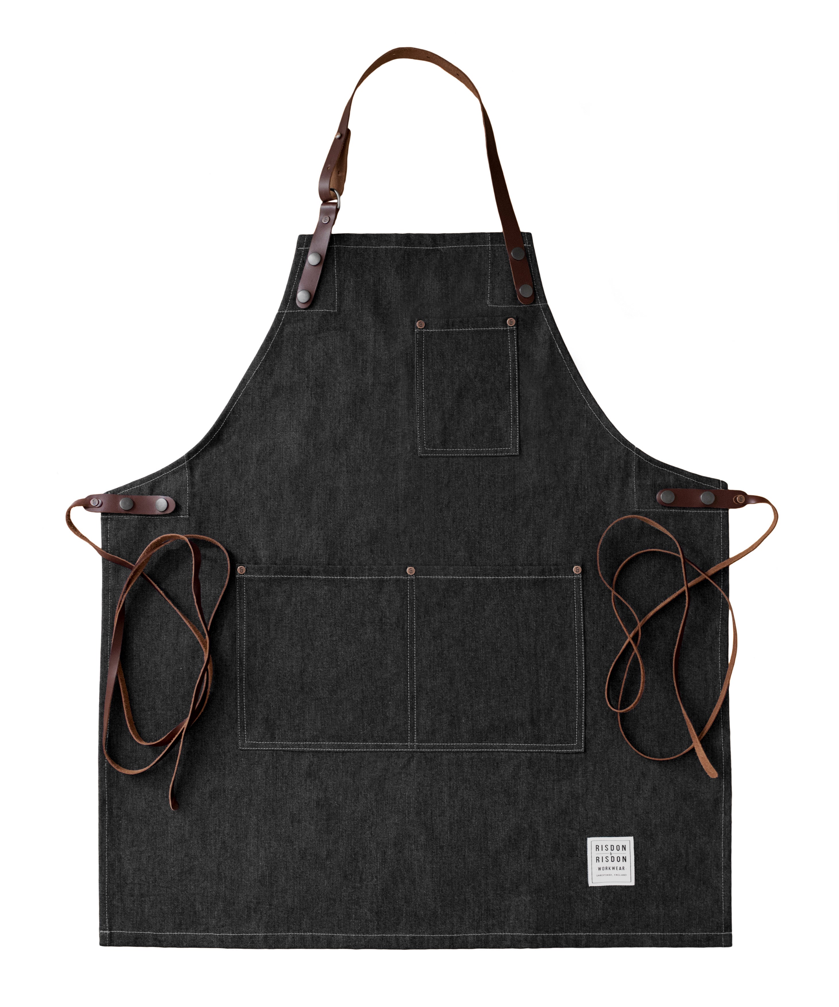 Handcrafted, black, denim apron; made in Britain with pockets and removable leather straps.