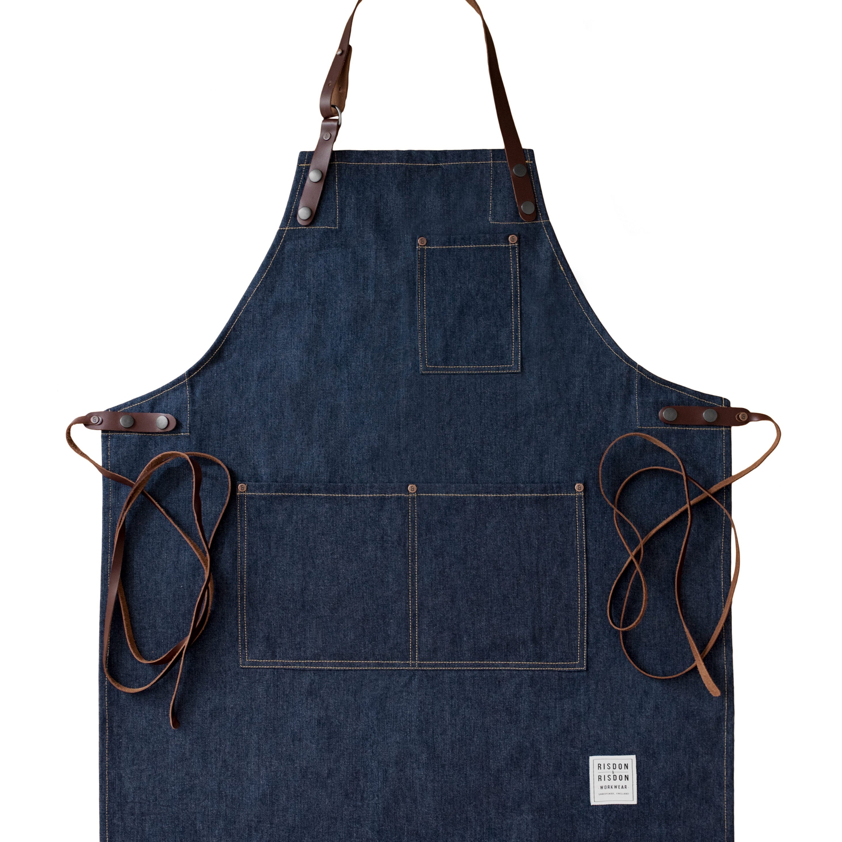 Handcrafted, heritage denim apron; made in Britain with pockets and removable leather straps.