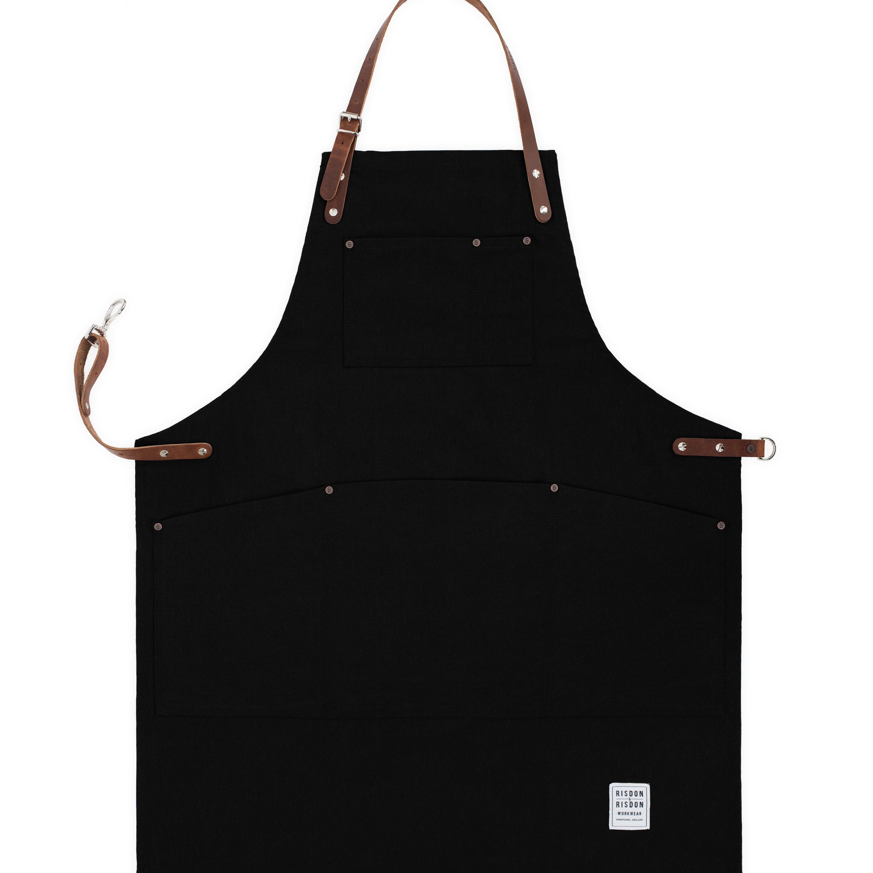 Handcrafted, black canvas apron; made in Britain with pockets and removable leather straps.