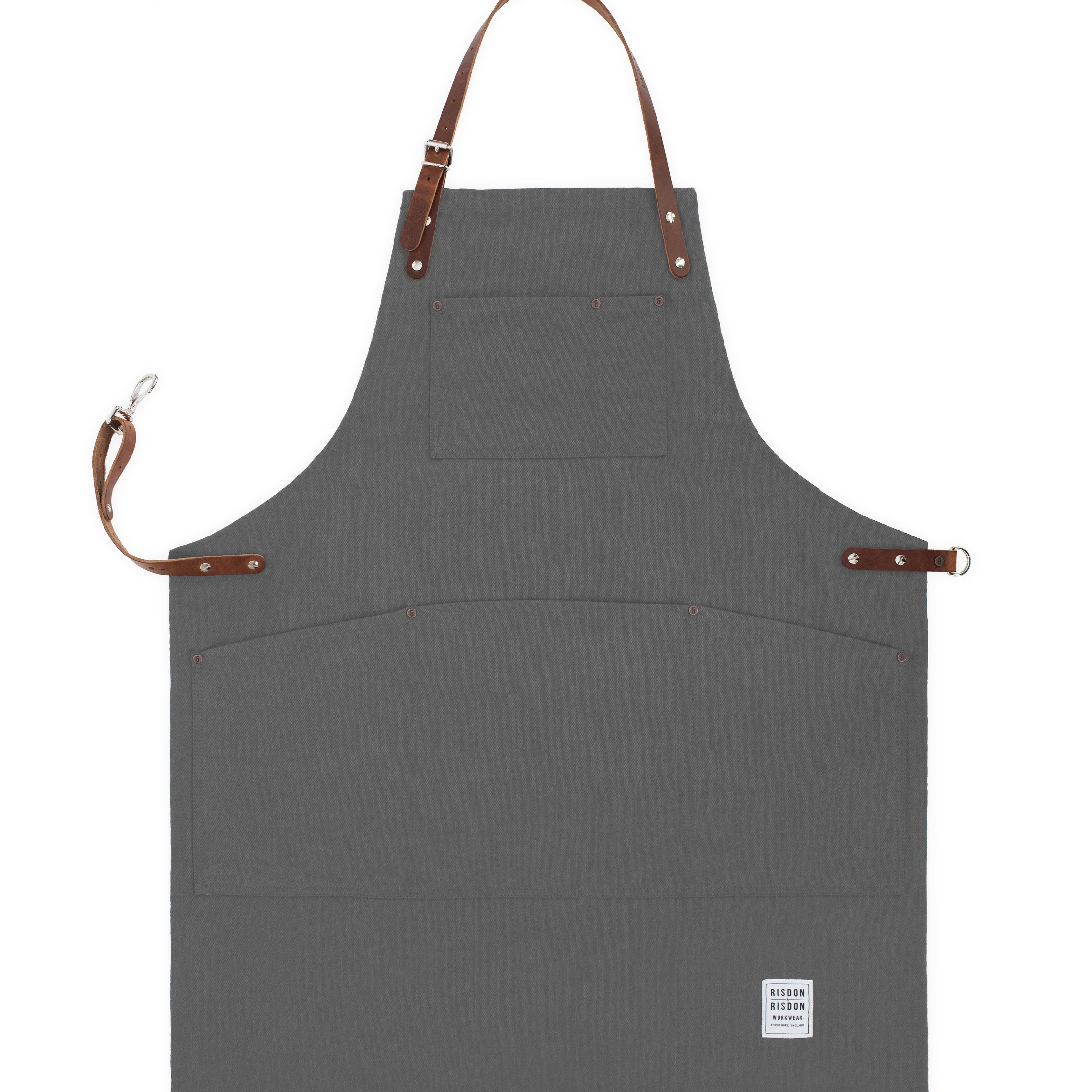 Handcrafted, heritage grey canvas apron; made in Britain with pockets and removable leather straps.