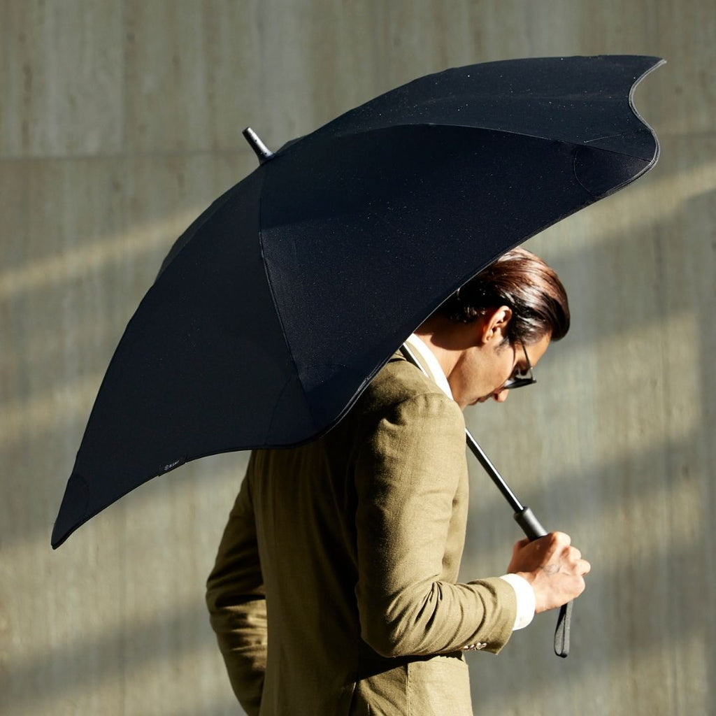 Man holding large black quality umbrella