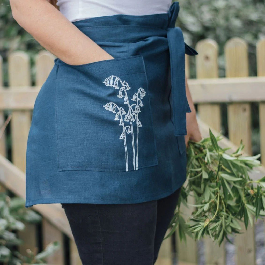 Blue linen half apron with flower detail
