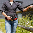 Elvis & Kresse clutch bag carried, lifestyle