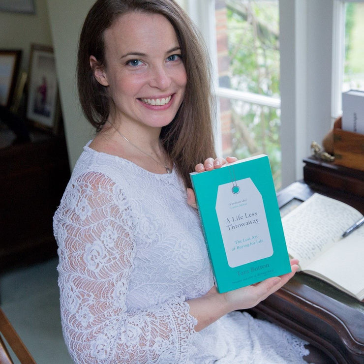 Tara Button holding her book ‘A Life Less Throwaway’ in the Buy Me Once test studio